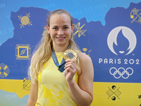 Ukrainian sabre fencer Yuliia Bakastova, who is winning gold in the Women's Sabre Team Gold Medal Match, is attending a news conference duri...