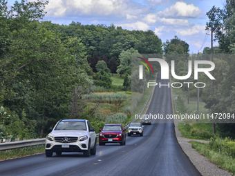 Vehicles are traveling along a steep rural road in Markham, Ontario, Canada, on August 10, 2024. (