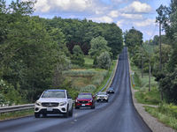 Vehicles are traveling along a steep rural road in Markham, Ontario, Canada, on August 10, 2024. (