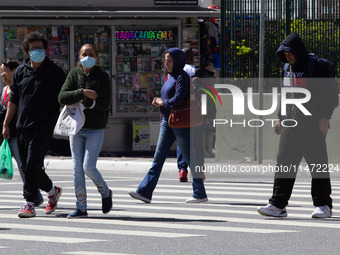 Pedestrians are protecting themselves from the cold in the central region of Sao Paulo, Brazil, on Monday, August 12. (