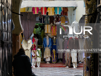 The shopkeeper is sitting by his shop as he waits for customers in Tangier, Morocco, Africa. (