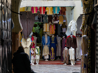 The shopkeeper is sitting by his shop as he waits for customers in Tangier, Morocco, Africa. (