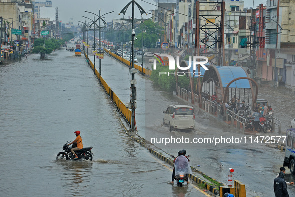 Vehicles are moving through the waterlogged Sikar Road following heavy monsoon rains in Jaipur, Rajasthan, India, on Monday, August 12, 2024...