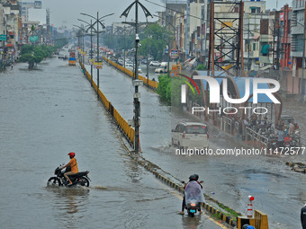 Vehicles are moving through the waterlogged Sikar Road following heavy monsoon rains in Jaipur, Rajasthan, India, on Monday, August 12, 2024...