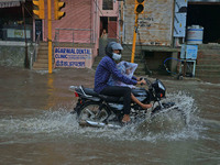 Vehicles are moving through the waterlogged Sikar Road following heavy monsoon rains in Jaipur, Rajasthan, India, on Monday, August 12, 2024...