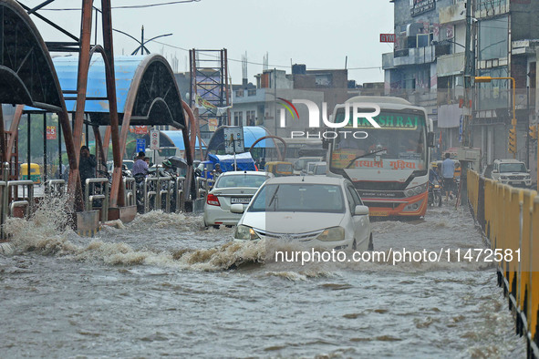 Vehicles are moving through the waterlogged Sikar Road following heavy monsoon rains in Jaipur, Rajasthan, India, on Monday, August 12, 2024...