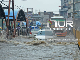 Vehicles are moving through the waterlogged Sikar Road following heavy monsoon rains in Jaipur, Rajasthan, India, on Monday, August 12, 2024...