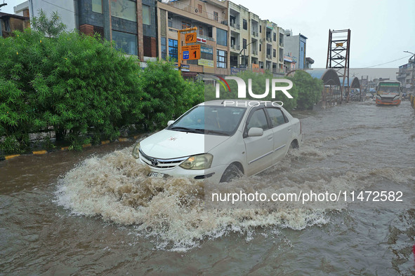 Vehicles are moving through the waterlogged Sikar Road following heavy monsoon rains in Jaipur, Rajasthan, India, on Monday, August 12, 2024...