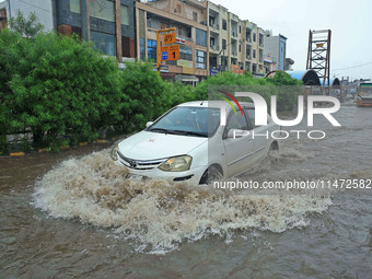 Vehicles are moving through the waterlogged Sikar Road following heavy monsoon rains in Jaipur, Rajasthan, India, on Monday, August 12, 2024...