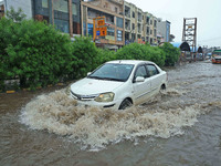 Vehicles are moving through the waterlogged Sikar Road following heavy monsoon rains in Jaipur, Rajasthan, India, on Monday, August 12, 2024...