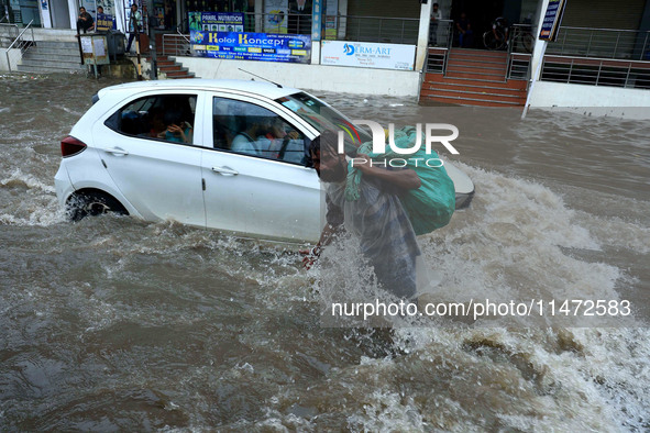 Vehicles are moving through the waterlogged Sikar Road following heavy monsoon rains in Jaipur, Rajasthan, India, on Monday, August 12, 2024...