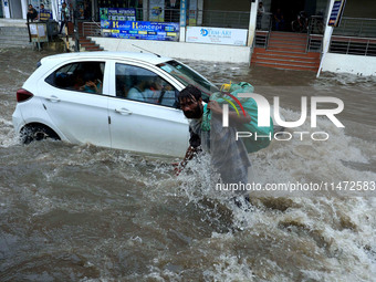 Vehicles are moving through the waterlogged Sikar Road following heavy monsoon rains in Jaipur, Rajasthan, India, on Monday, August 12, 2024...