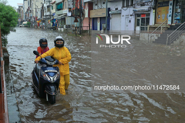 Vehicles are moving through the waterlogged Sikar Road following heavy monsoon rains in Jaipur, Rajasthan, India, on Monday, August 12, 2024...