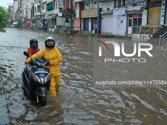 Vehicles are moving through the waterlogged Sikar Road following heavy monsoon rains in Jaipur, Rajasthan, India, on Monday, August 12, 2024...