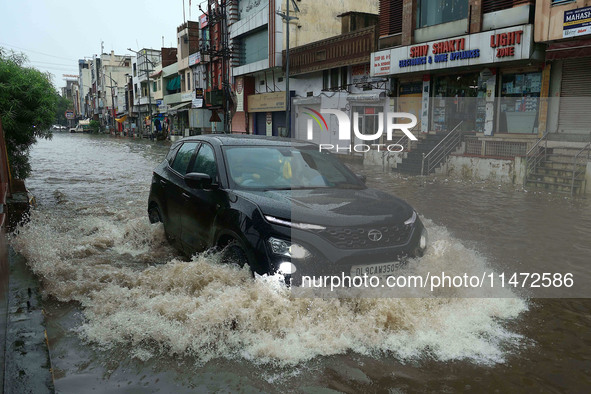 Vehicles are moving through the waterlogged Sikar Road following heavy monsoon rains in Jaipur, Rajasthan, India, on Monday, August 12, 2024...