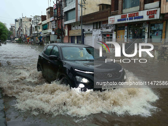 Vehicles are moving through the waterlogged Sikar Road following heavy monsoon rains in Jaipur, Rajasthan, India, on Monday, August 12, 2024...