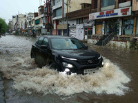 Vehicles are moving through the waterlogged Sikar Road following heavy monsoon rains in Jaipur, Rajasthan, India, on Monday, August 12, 2024...