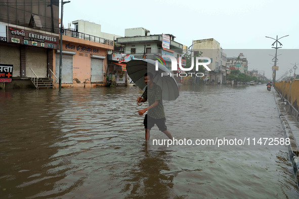 Locals are at waterlogged Sikar Road following heavy monsoon rains, in Jaipur, Rajasthan, India, on August 12, 2024. 