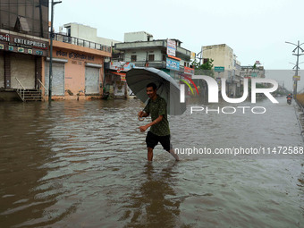 Locals are at waterlogged Sikar Road following heavy monsoon rains, in Jaipur, Rajasthan, India, on August 12, 2024. (