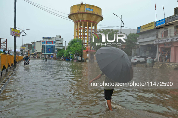 Locals are at waterlogged Sikar Road following heavy monsoon rains, in Jaipur, Rajasthan, India, on August 12, 2024. 