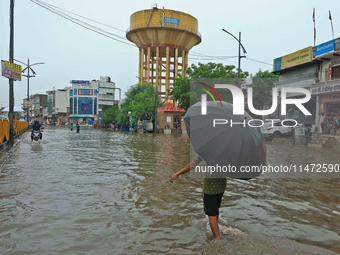 Locals are at waterlogged Sikar Road following heavy monsoon rains, in Jaipur, Rajasthan, India, on August 12, 2024. (