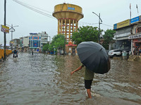 Locals are at waterlogged Sikar Road following heavy monsoon rains, in Jaipur, Rajasthan, India, on August 12, 2024. (