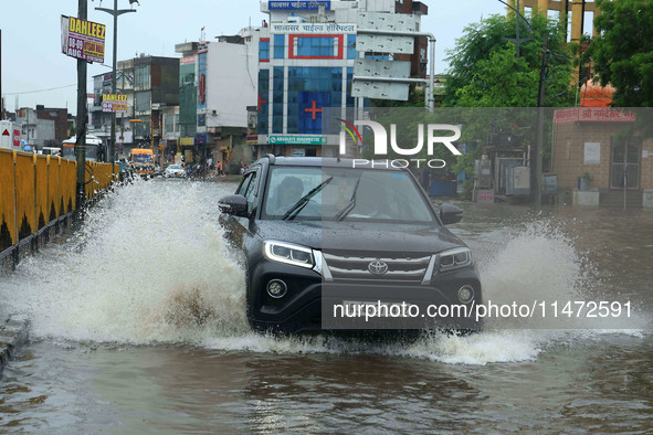 Vehicles are moving through the waterlogged Sikar Road following heavy monsoon rains in Jaipur, Rajasthan, India, on Monday, August 12, 2024...