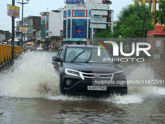 Vehicles are moving through the waterlogged Sikar Road following heavy monsoon rains in Jaipur, Rajasthan, India, on Monday, August 12, 2024...