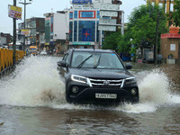 Vehicles are moving through the waterlogged Sikar Road following heavy monsoon rains in Jaipur, Rajasthan, India, on Monday, August 12, 2024...