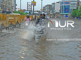 Vehicles are moving through the waterlogged Sikar Road following heavy monsoon rains in Jaipur, India, on August 12, 2024. (