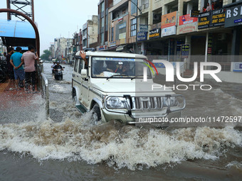 Vehicles are moving through the waterlogged Sikar Road following heavy monsoon rains in Jaipur, Rajasthan, India, on Monday, August 12, 2024...