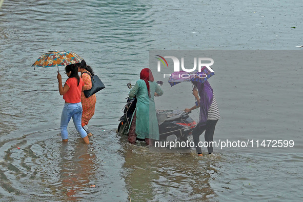 Vehicles are moving through the waterlogged Sikar Road following heavy monsoon rains in Jaipur, Rajasthan, India, on Monday, August 12, 2024...