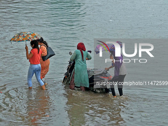 Vehicles are moving through the waterlogged Sikar Road following heavy monsoon rains in Jaipur, Rajasthan, India, on Monday, August 12, 2024...