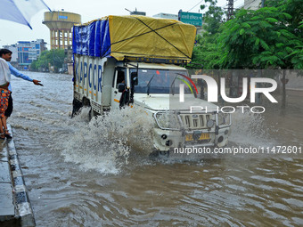 Vehicles are moving through the waterlogged Sikar Road following heavy monsoon rains in Jaipur, Rajasthan, India, on Monday, August 12, 2024...