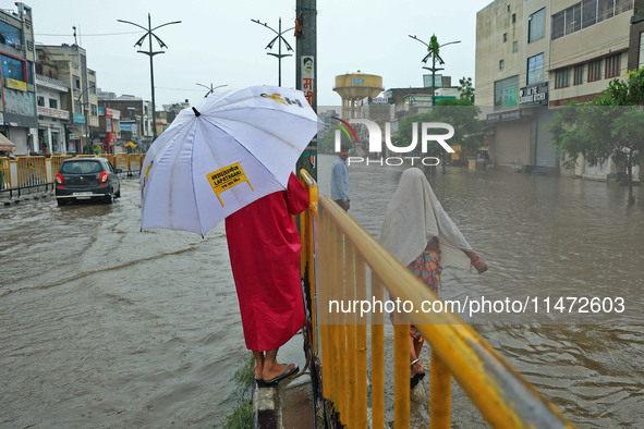 Locals are at waterlogged Sikar Road following heavy monsoon rains, in Jaipur, Rajasthan, India, on August 12, 2024. 