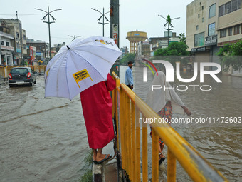 Locals are at waterlogged Sikar Road following heavy monsoon rains, in Jaipur, Rajasthan, India, on August 12, 2024. (