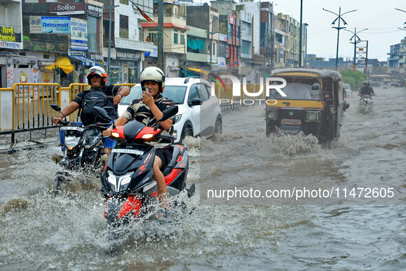 Vehicles are moving through the waterlogged Sikar Road following heavy monsoon rains in Jaipur, Rajasthan, India, on Monday, August 12, 2024...