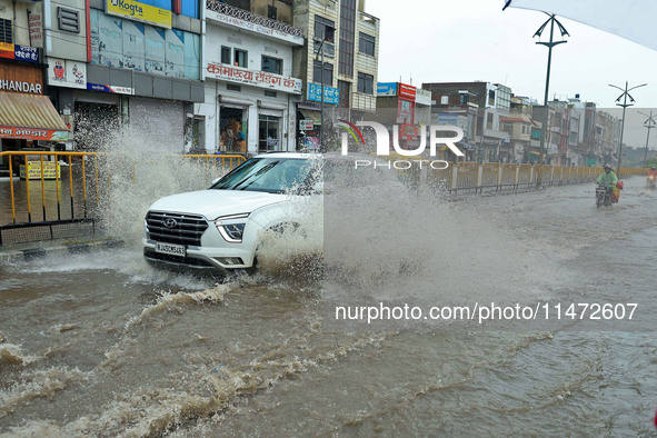 Vehicles are moving through the waterlogged Sikar Road following heavy monsoon rains in Jaipur, Rajasthan, India, on Monday, August 12, 2024...