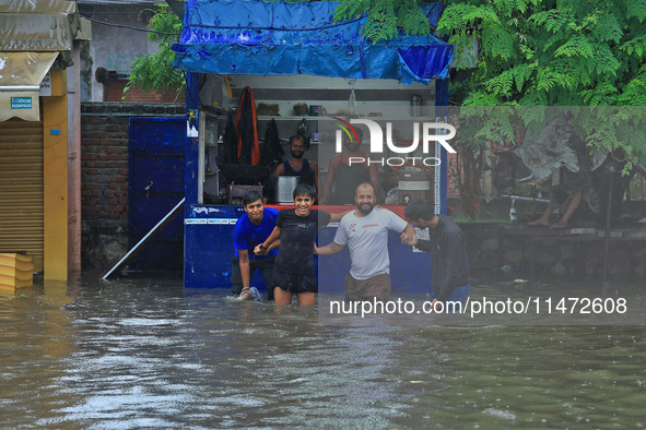 Locals are at waterlogged Sikar Road following heavy monsoon rains, in Jaipur, Rajasthan, India, on August 12, 2024. 