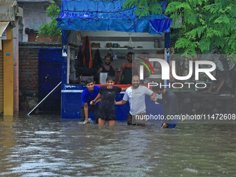 Locals are at waterlogged Sikar Road following heavy monsoon rains, in Jaipur, Rajasthan, India, on August 12, 2024. (