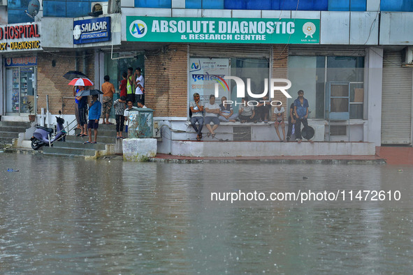 Locals are at waterlogged Sikar Road following heavy monsoon rains, in Jaipur, Rajasthan, India, on August 12, 2024. 