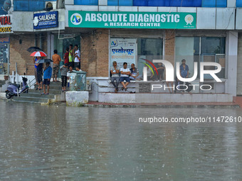 Locals are at waterlogged Sikar Road following heavy monsoon rains, in Jaipur, Rajasthan, India, on August 12, 2024. (