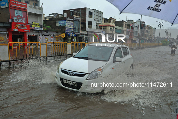 Vehicles are moving through the waterlogged Sikar Road following heavy monsoon rains in Jaipur, Rajasthan, India, on Monday, August 12, 2024...