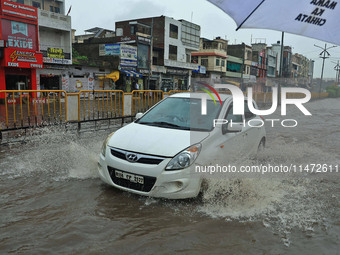 Vehicles are moving through the waterlogged Sikar Road following heavy monsoon rains in Jaipur, Rajasthan, India, on Monday, August 12, 2024...