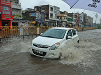 Vehicles are moving through the waterlogged Sikar Road following heavy monsoon rains in Jaipur, Rajasthan, India, on Monday, August 12, 2024...