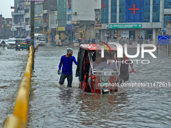 Vehicles are moving through the waterlogged Sikar Road following heavy monsoon rains in Jaipur, Rajasthan, India, on Monday, August 12, 2024...