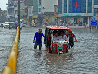 Vehicles are moving through the waterlogged Sikar Road following heavy monsoon rains in Jaipur, Rajasthan, India, on Monday, August 12, 2024...