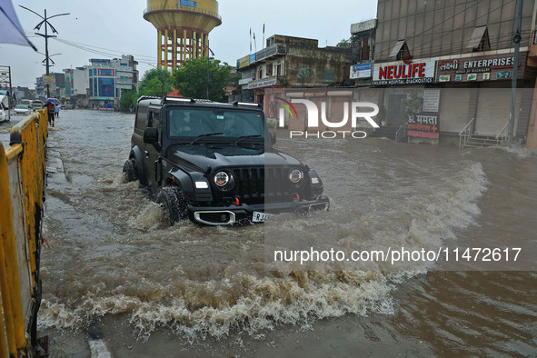 Vehicles are moving through the waterlogged Sikar Road following heavy monsoon rains in Jaipur, Rajasthan, India, on Monday, August 12, 2024...