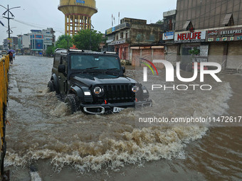 Vehicles are moving through the waterlogged Sikar Road following heavy monsoon rains in Jaipur, Rajasthan, India, on Monday, August 12, 2024...