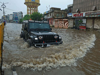 Vehicles are moving through the waterlogged Sikar Road following heavy monsoon rains in Jaipur, Rajasthan, India, on Monday, August 12, 2024...